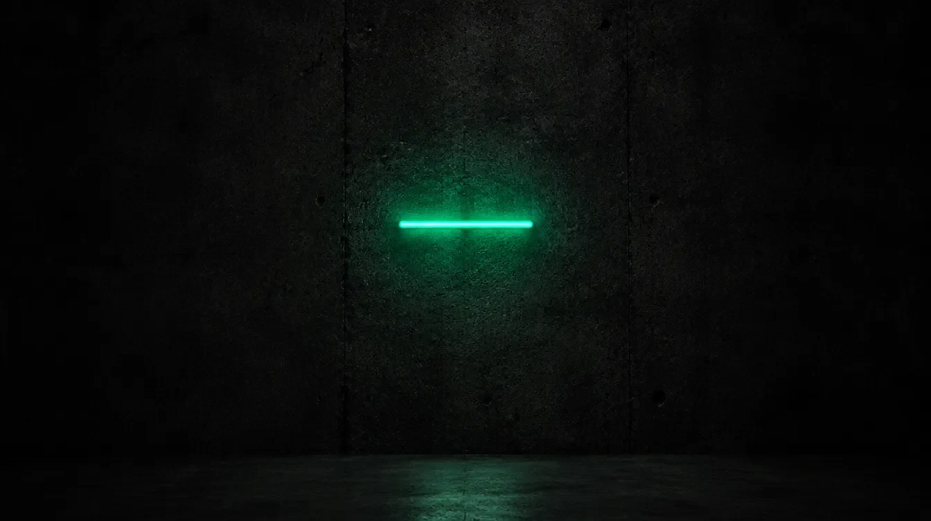 A short bar of green neon light glowing on a dark concrete wall