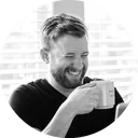 Jon Phillips, laughing over a cup of coffee